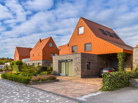 Modern architecture houses with remarkable red roof tiles in a contemporary suburban neighborhood in the Netherlandsのeditorial素材