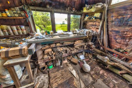Very messy workbench in a wooden barnの写真素材