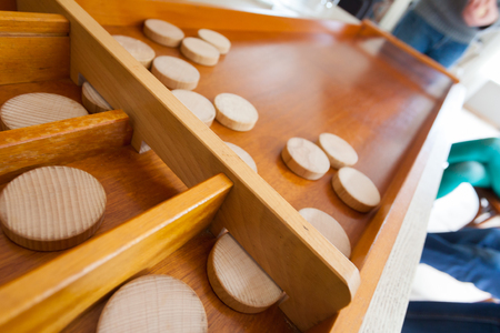 Traditional game of the Netherlands called sjoelen. The wooden disks have to go in the holes