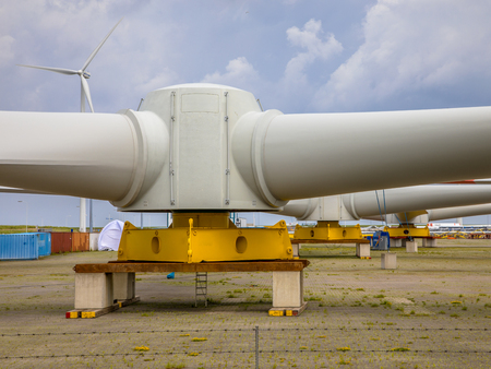 Giant rotors of wind turbine on windmill construction yard to build windfarms at sea