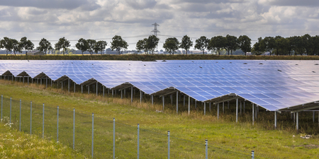Solar panels of a photovoltaic system in industrial area on summer day