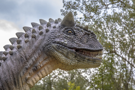 Carnosaurus dinosaur head in natural bush