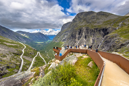 Tourists on viewing balcony at Trollstigen road tourist attraction in More og Romsdal region Norwayの写真素材