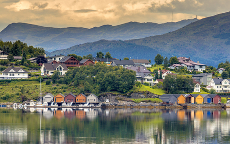 Scenic village on the coastline of fjord with colorful boathouses near Ulsteinvik Norwayのeditorial素材