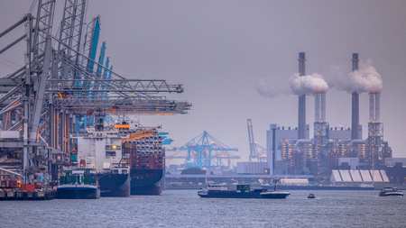 Rotterdam europoort industrial harbor landscape with unloading ships and working factoriesのeditorial素材