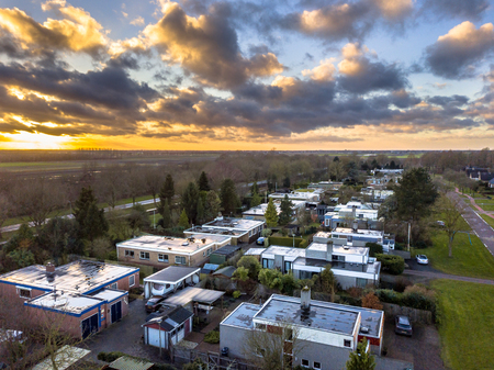 Aerial view Flat roof bungalow houses in residential area on dutch countryside in Groningen Province, Netherlandsの写真素材