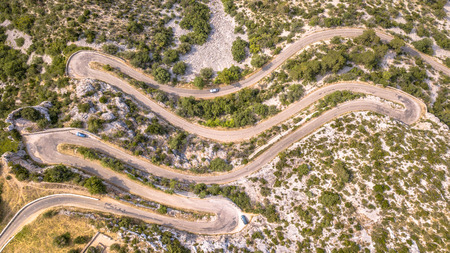 Aerial top down view of Hairbpin bend road in Cevennes, Occitania, Franceの写真素材