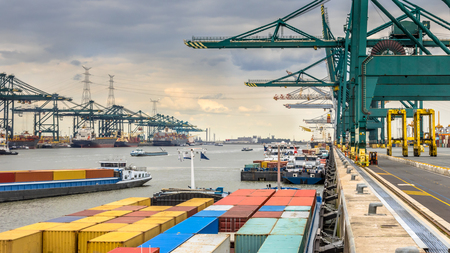 Loaded ships in busy port of Antwerp at container terminal with automated cranes and lots of vessels. Belgiumの写真素材