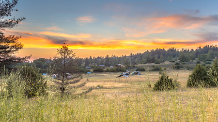 Sunset over camping ground on plateau of the Causse Noir in Cevennes National park, Occitanie, Franceの写真素材