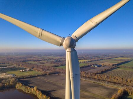 Close up aerial view of Rotor and Nacelle of Wind Turbine in german countryside on a sunny day