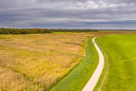 Aerial view of Cycling track over a river dike in National Park Wieden Weerribben, Wetering,...