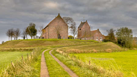 Church on dwelling mound terp in village of Ezinge, Groningen Province, the Netherlands. Historic...