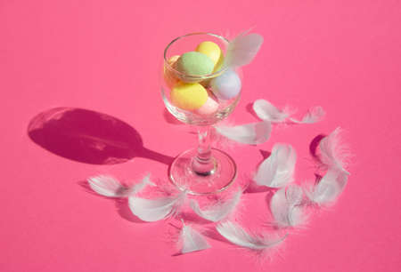 Creative Easter cocktail made of eggs and feathers on pink background. Happy Easter 2021.の写真素材