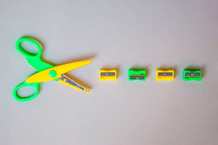 Back to school concept with school supplies, scissors and pencil sharpeners on grey background. Top view with copy space. Flat lay.の写真素材