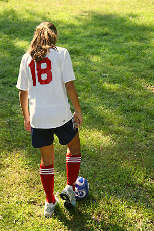 Young girl playing soccerの写真素材