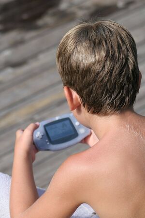 young boy playing video gamesの写真素材