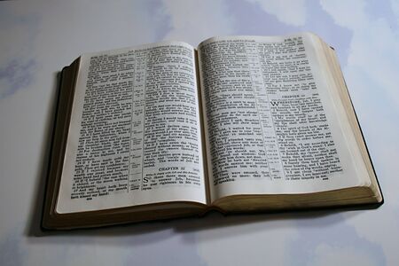 holy bible open on cloud backgroundの写真素材