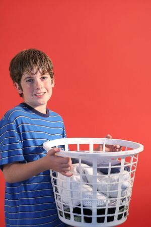 boy holding laundry angleの写真素材