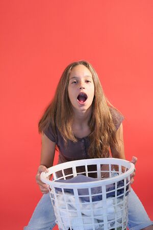 girl with laundry basket verticalの写真素材