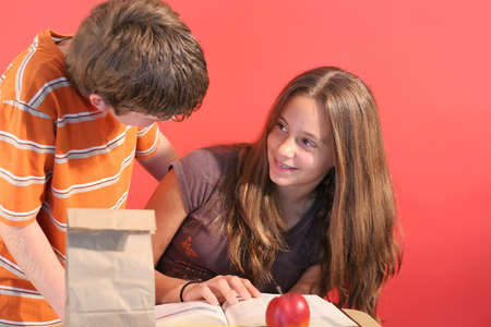 boy helping girl with homeworkの写真素材