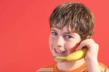 Boy on banana phoneの写真素材