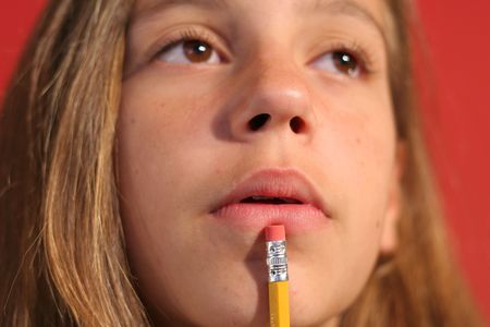 girl thinking with pencilの写真素材