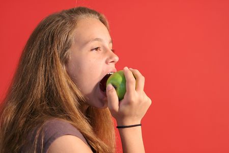 girl eating an appleの写真素材