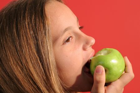 girl eating an apple upcloseの写真素材