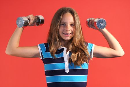 girl lifting dumbell weightsの写真素材