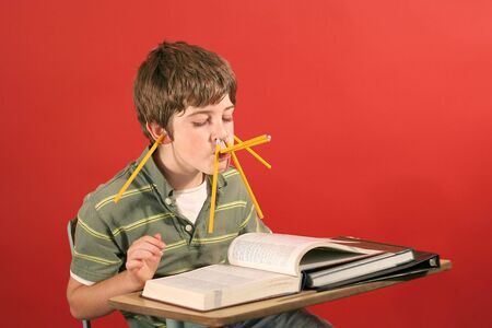 kid goofying off while studyingの写真素材
