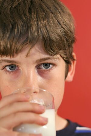 boy drinking milk vertical upcloseの写真素材