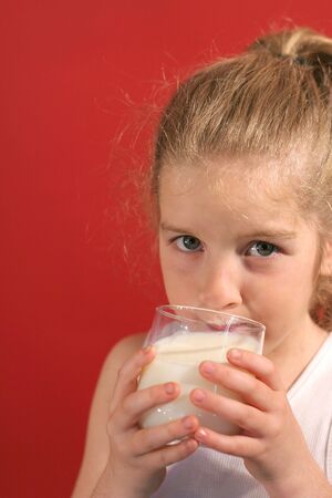 little girl sipping milkの写真素材