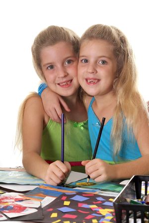 sisters coloring together verticalの写真素材