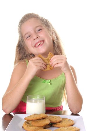 happy little girl eating cookiesの写真素材
