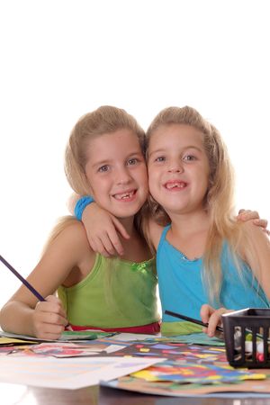 sisters hugging doing craftsの写真素材