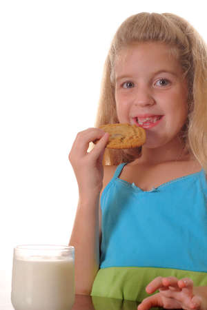 little girl eating chocolate chip cookieの写真素材