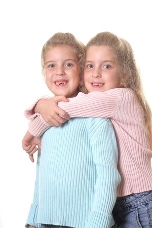 identical twin sisters on whiteの写真素材