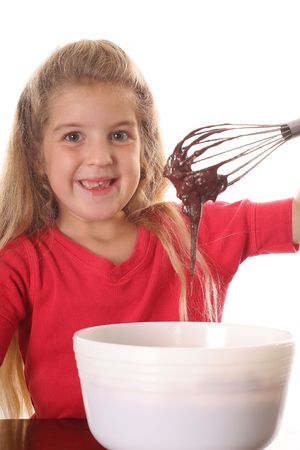 happy little girl mixing brownie batter vertical upcloseの写真素材