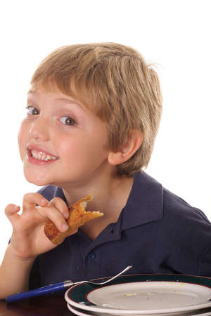 young child smiling over breakfastの写真素材