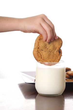 dipping cookie in milk verticalの写真素材