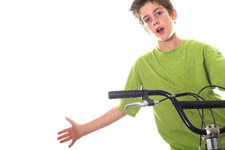 young boy riding bicycle with hand outの写真素材