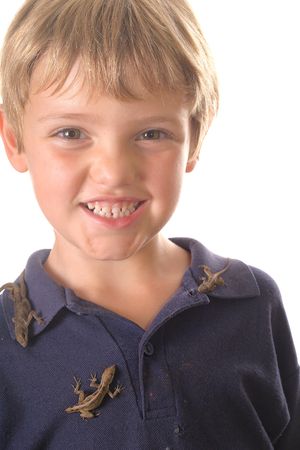 little boy with pet lizards all over himの写真素材