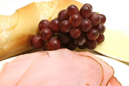 ham, bread, grapes and cheese snack up closeの写真素材