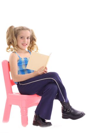 happy little girl reading a bookの写真素材