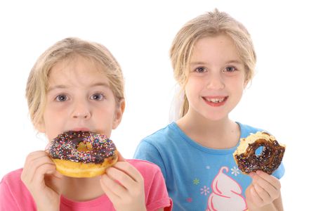 twin sisters eating a doughnutの写真素材