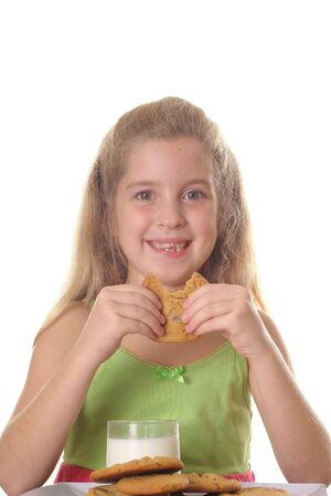 young child eating chocolate chip cookieの写真素材
