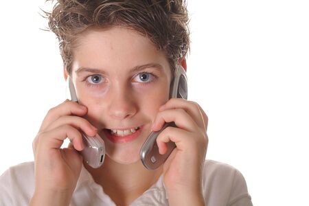 young boy talking on two cell phonesの写真素材