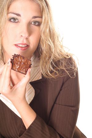 gorgeous woman eating a brownie の写真素材
