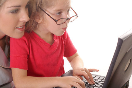 little girl checking emails with mom