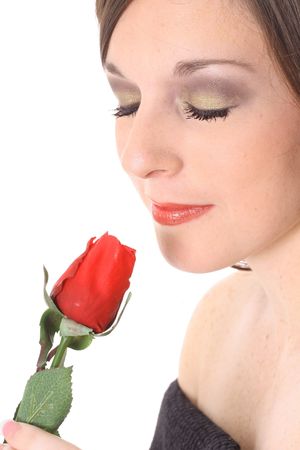 gorgeous woman smelling a roseの写真素材